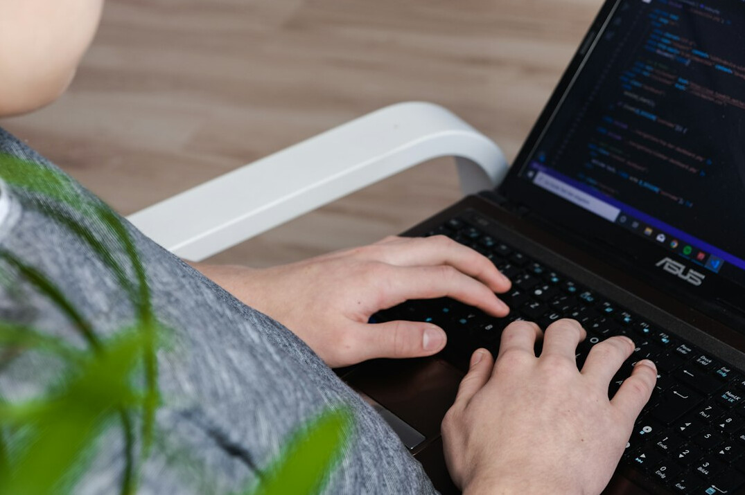 person using laptop for coding
