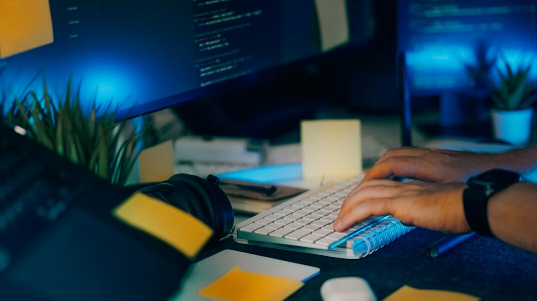 young programmer coding at desk